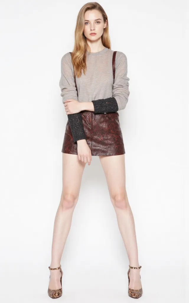 A French female model wearing Mod   style clothing, against a white background, in a front   facing shot focusing on shoes